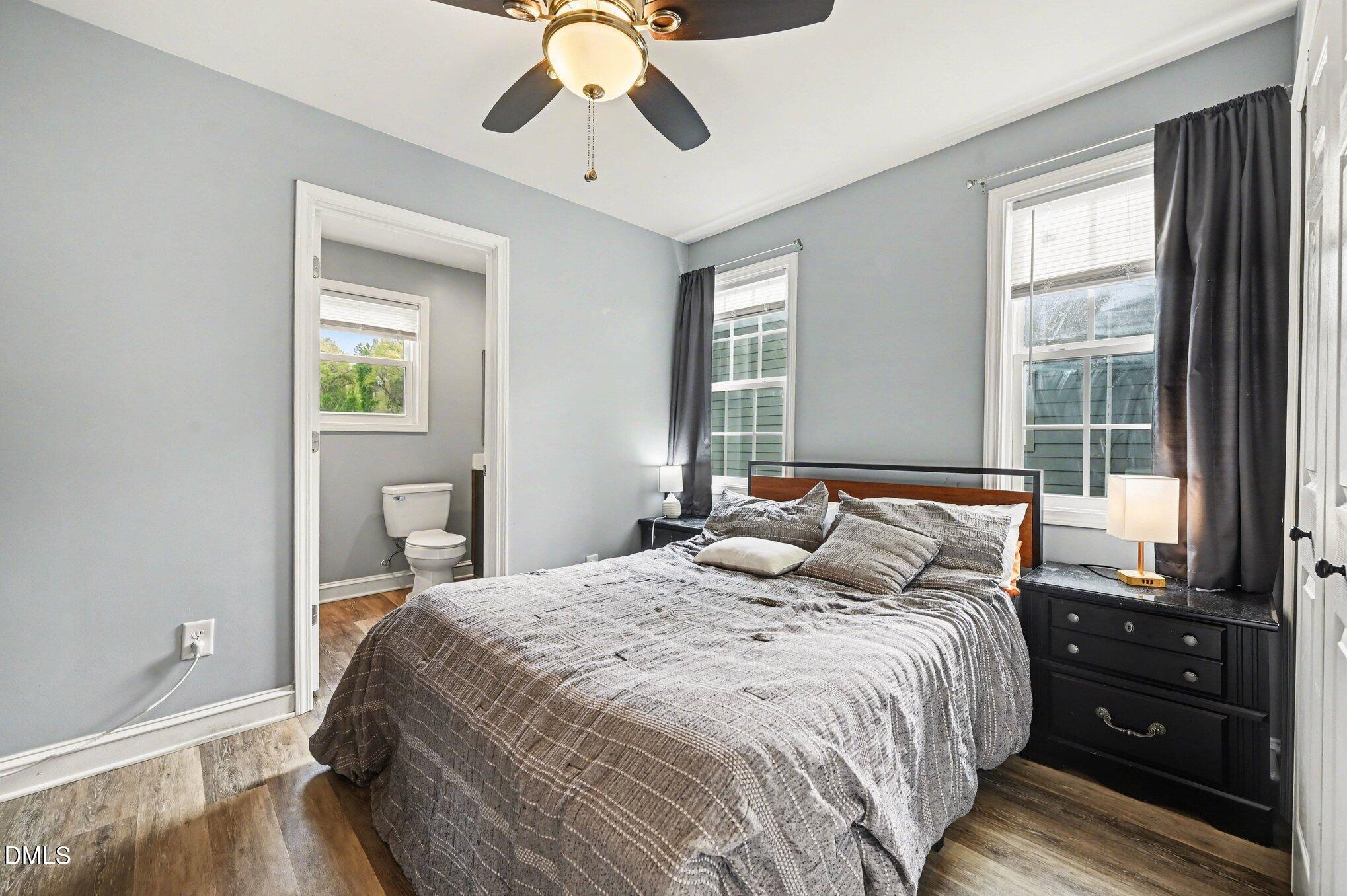 125 Barnhill Street Durham, NC 27707 - Photo 13 of 27 a bedroom with a bed and wooden floor