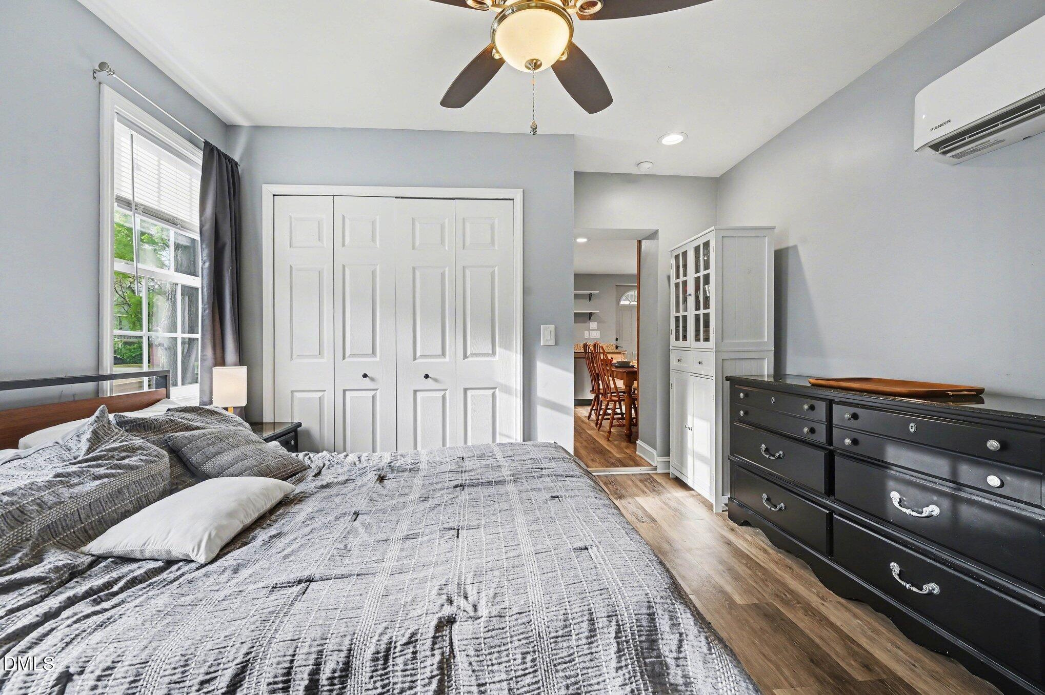125 Barnhill Street Durham, NC 27707 - Photo 14 of 27 a spacious bedroom with a bed and a chandelier