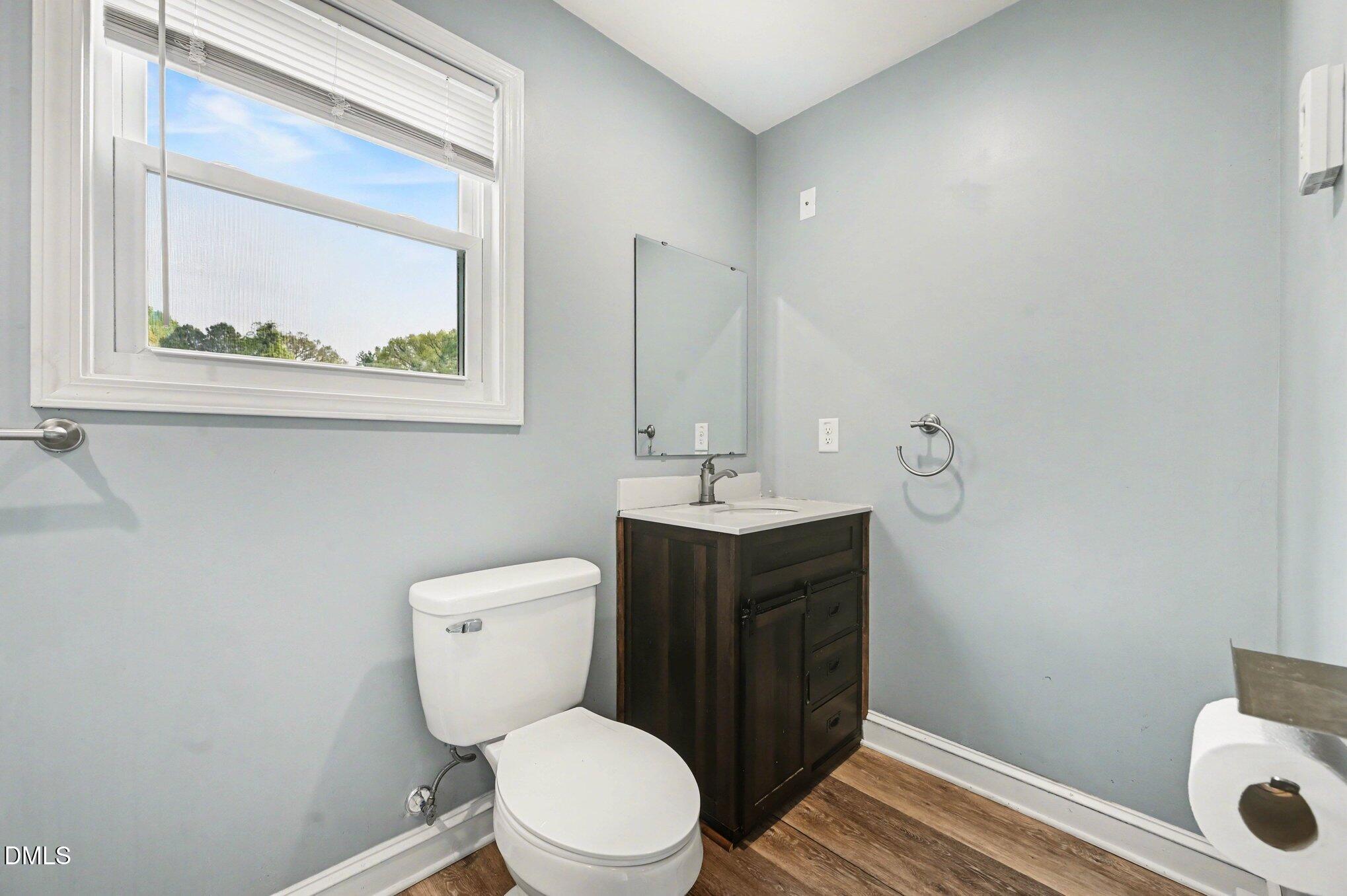 125 Barnhill Street Durham, NC 27707 - Photo 19 of 27 a bathroom with a toilet a sink and mirror