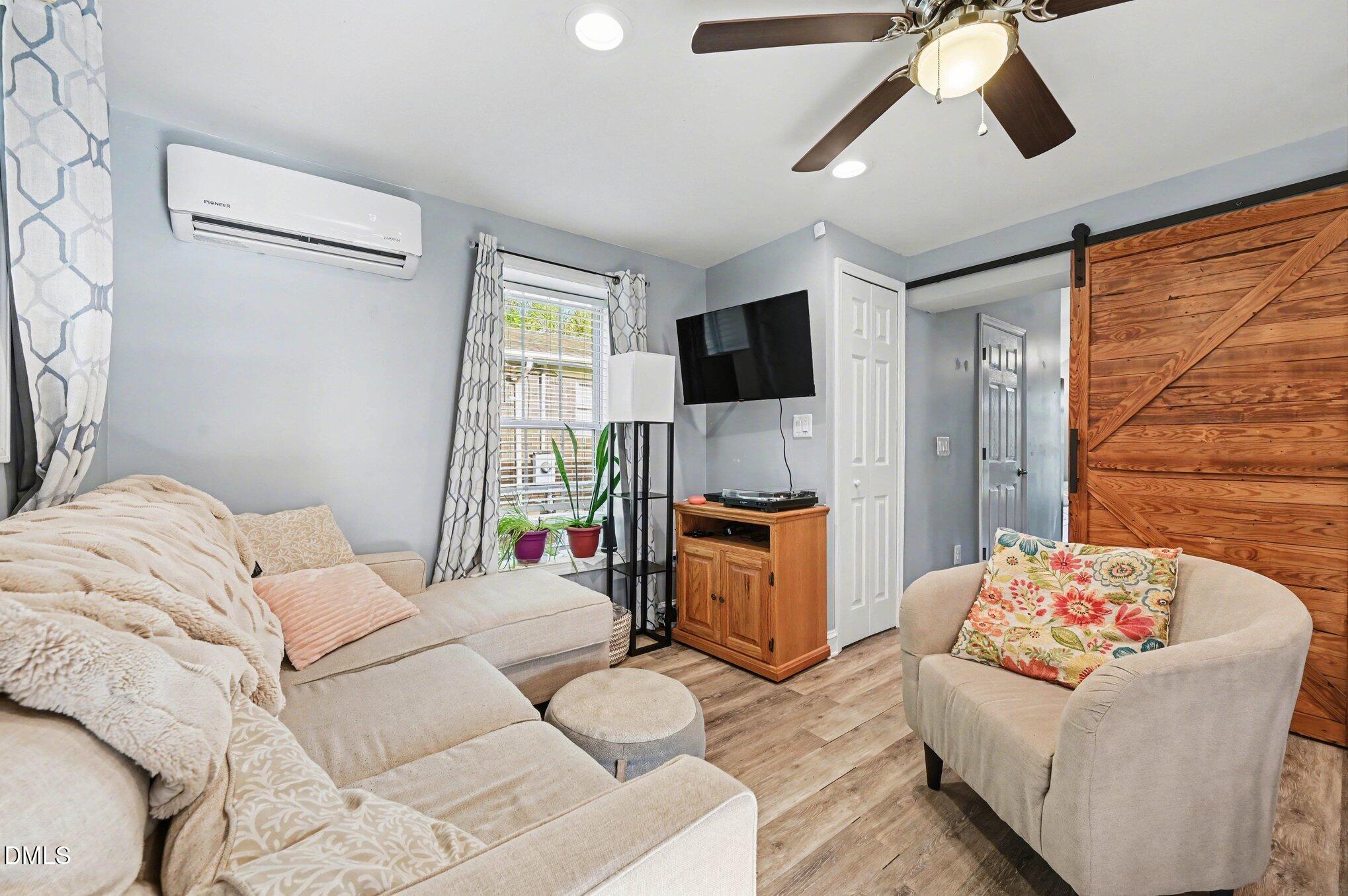 125 Barnhill Street Durham, NC 27707 - Photo 7 of 27 a bedroom with a bed couch and window