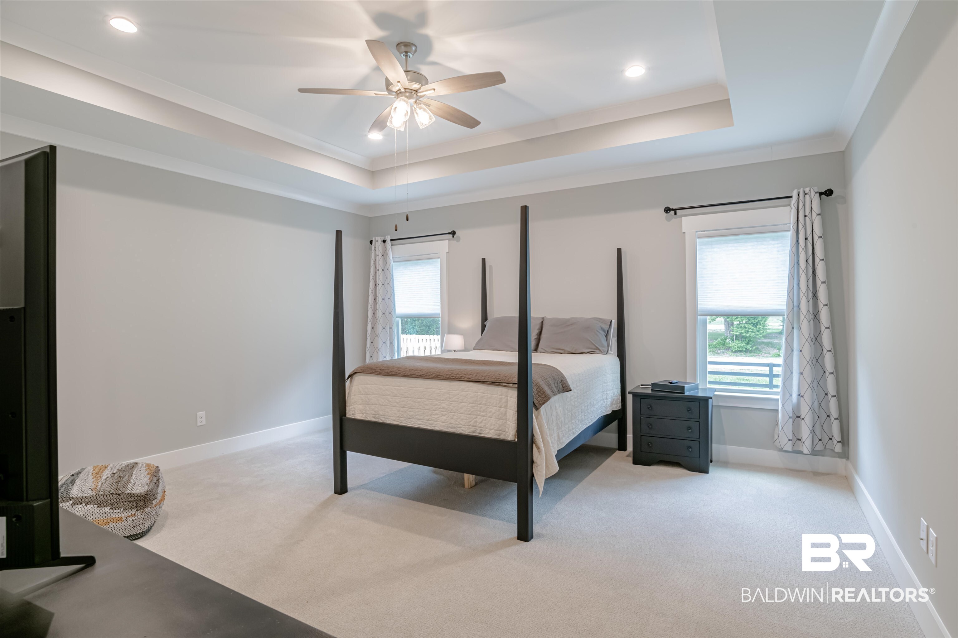 655 H Norman Lane Fairhope, AL 36532 - Photo 15 of 30 Carpeted bedroom featuring a raised ceiling, ceiling fan, and ornamental molding