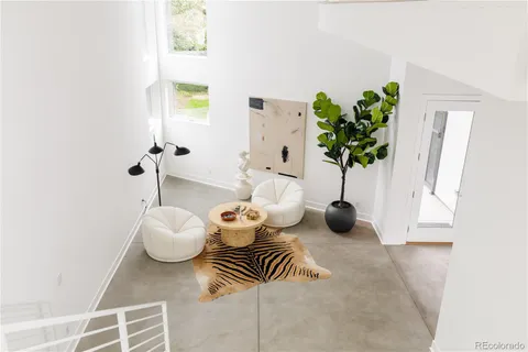 a living room with furniture and a potted plant