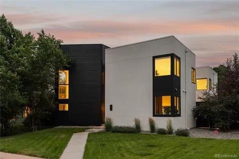 a front view of a house with a garden and yard