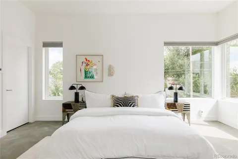 a bedroom with a large bed and a window