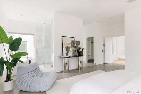 a bedroom with a bed furniture and a potted plant