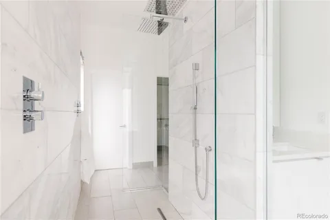 a bathroom with a shower and a glass door