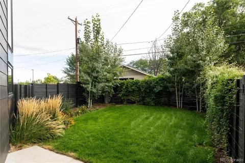 a backyard of a house with lots of green space and lake view