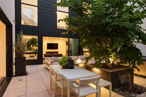 a lobby with furniture and potted plants