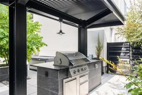 a roof deck with furniture and potted plants