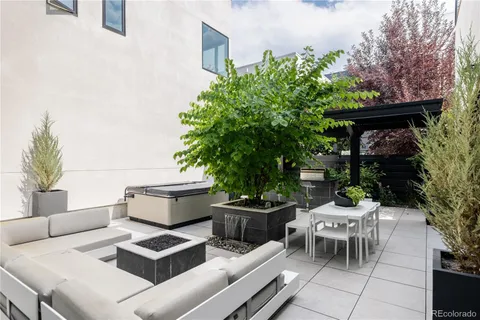 a view of backyard with outdoor seating and green space
