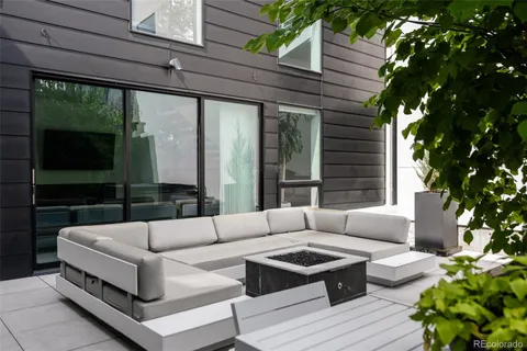 a view of a patio with couches and a potted plant on a table