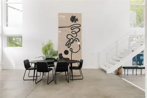 a view of a dining room with furniture and a potted plant