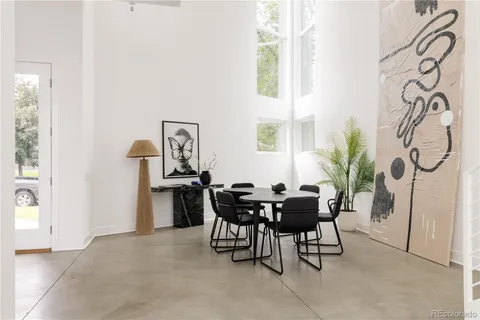 a view of a dining room with furniture and a window
