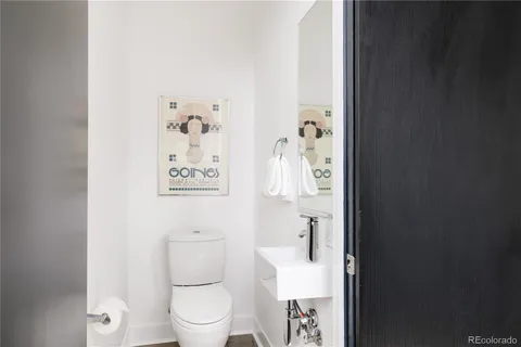 a white toilet sitting next to a bathroom sink