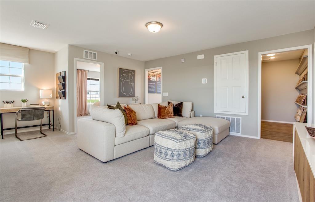 313 Hopson Street Van Alstyne, TX 75495 - Photo 1 of 16 a spacious bedroom with a bed and a couch