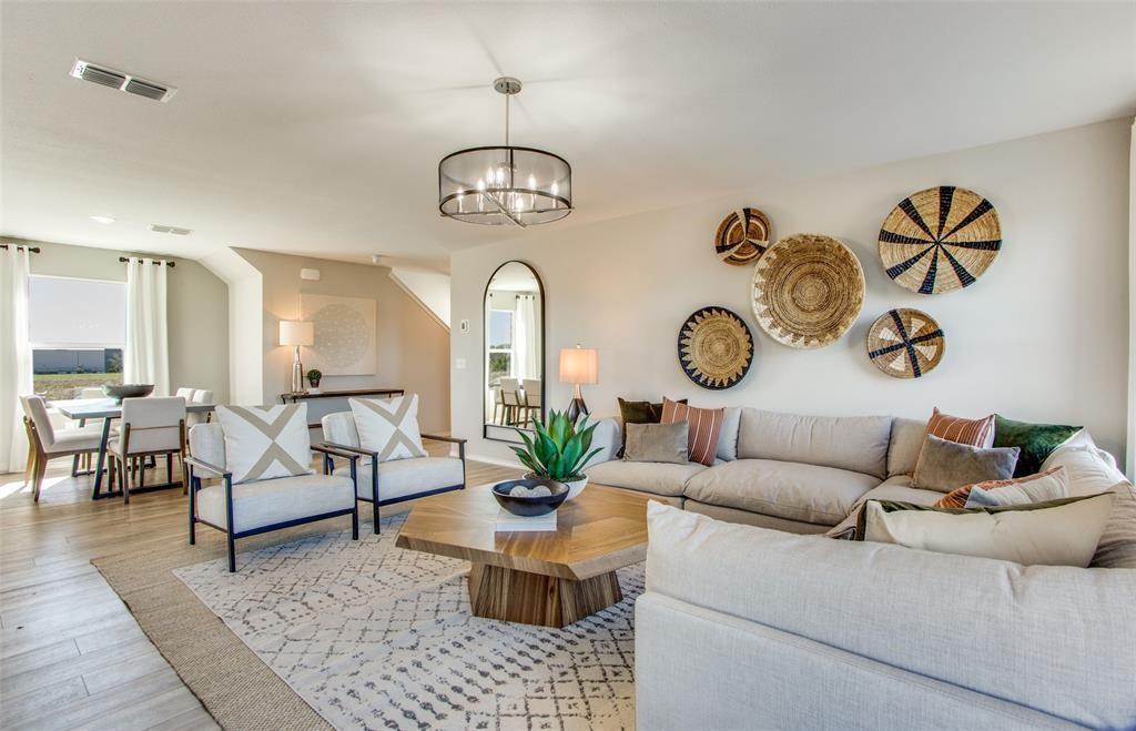 313 Hopson Street Van Alstyne, TX 75495 - Photo 11 of 16 a living room with furniture a rug and white walls