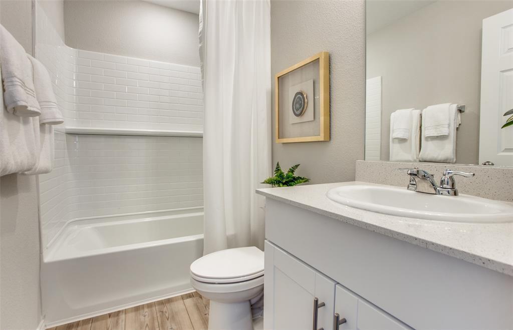 313 Hopson Street Van Alstyne, TX 75495 - Photo 6 of 16 a bathroom with a sink and a mirror