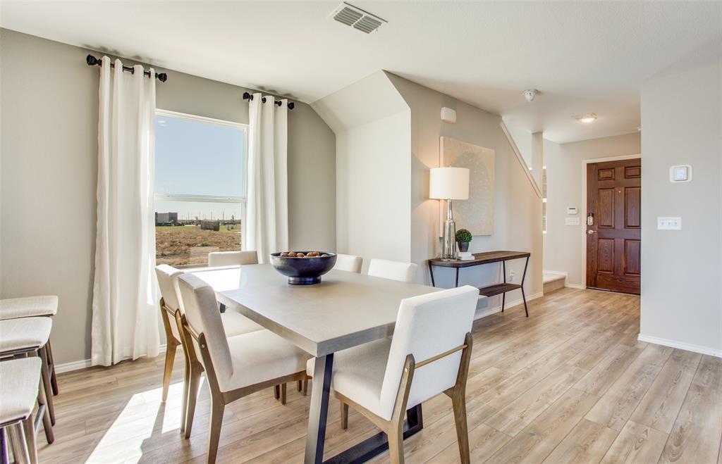 313 Hopson Street Van Alstyne, TX 75495 - Photo 7 of 16 a view of a dining room with furniture and wooden floor