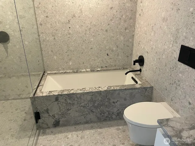 a bathroom with a toilet and a sink