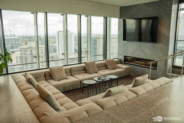 a living room with furniture and large windows