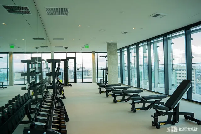 a living room with furniture and a floor to ceiling window