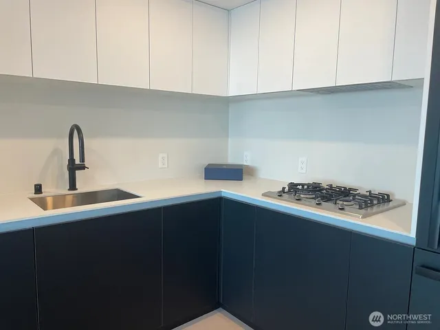 a kitchen with a sink and cabinets