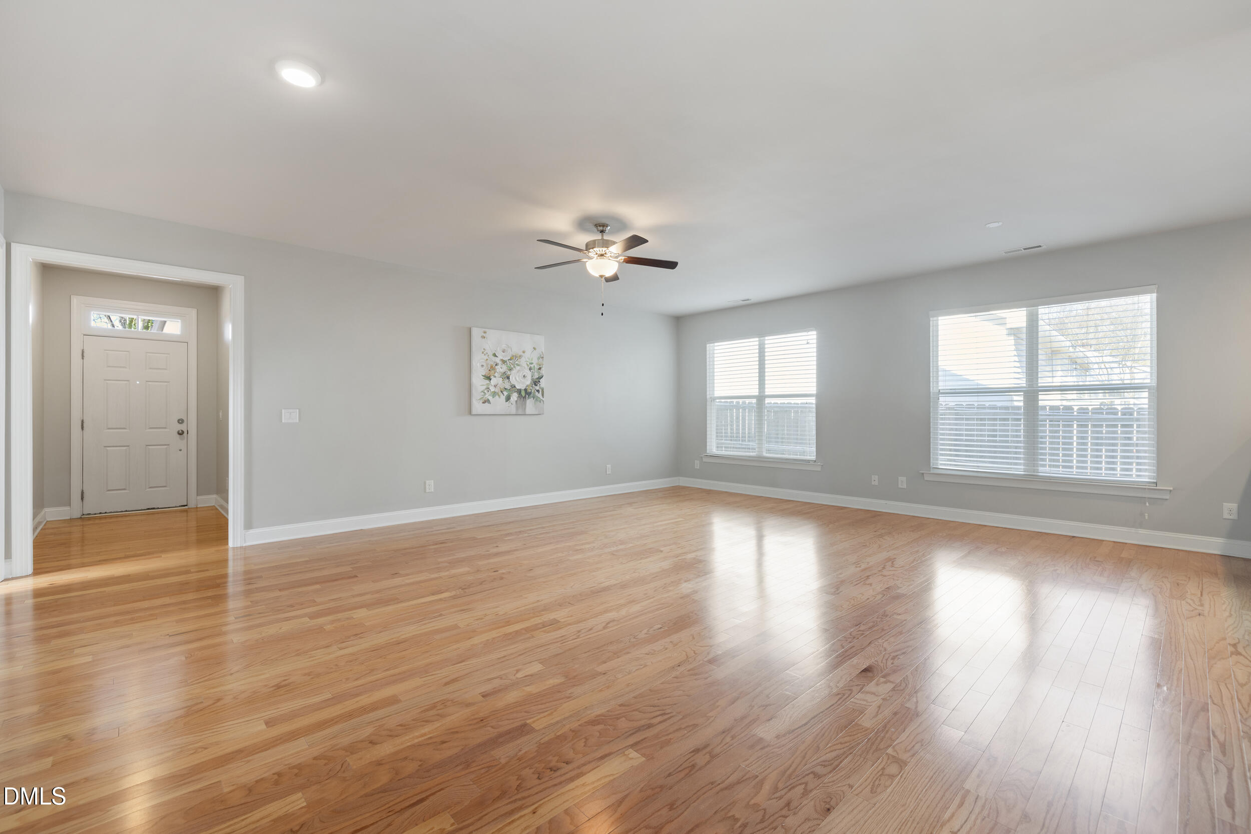 213 Forestville Road Wake Forest, NC 27587 - Photo 3 of 15 an empty room with wooden floor and windows