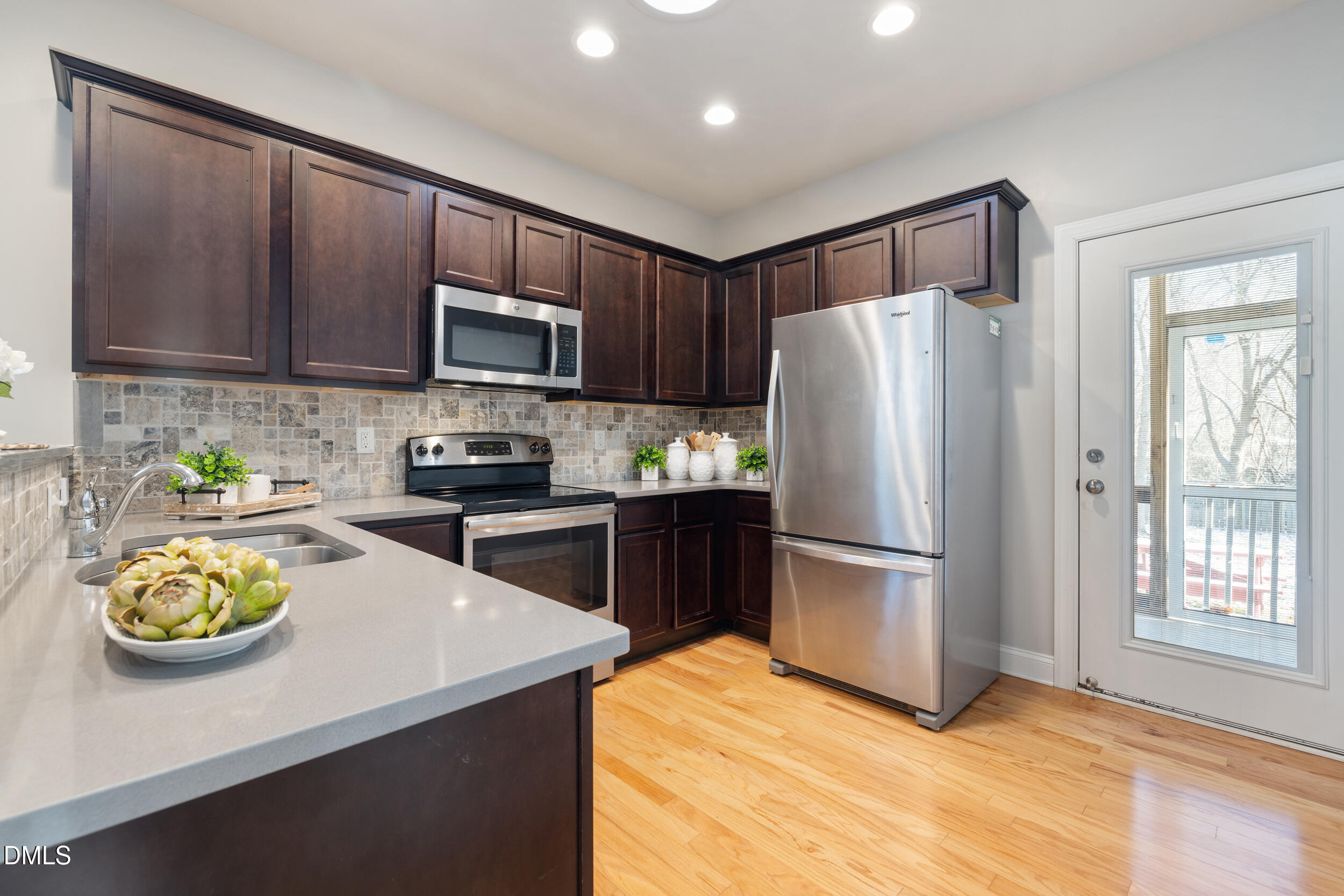 213 Forestville Road Wake Forest, NC 27587 - Photo 4 of 15 a kitchen with a refrigerator a stove a microwave and cabinets