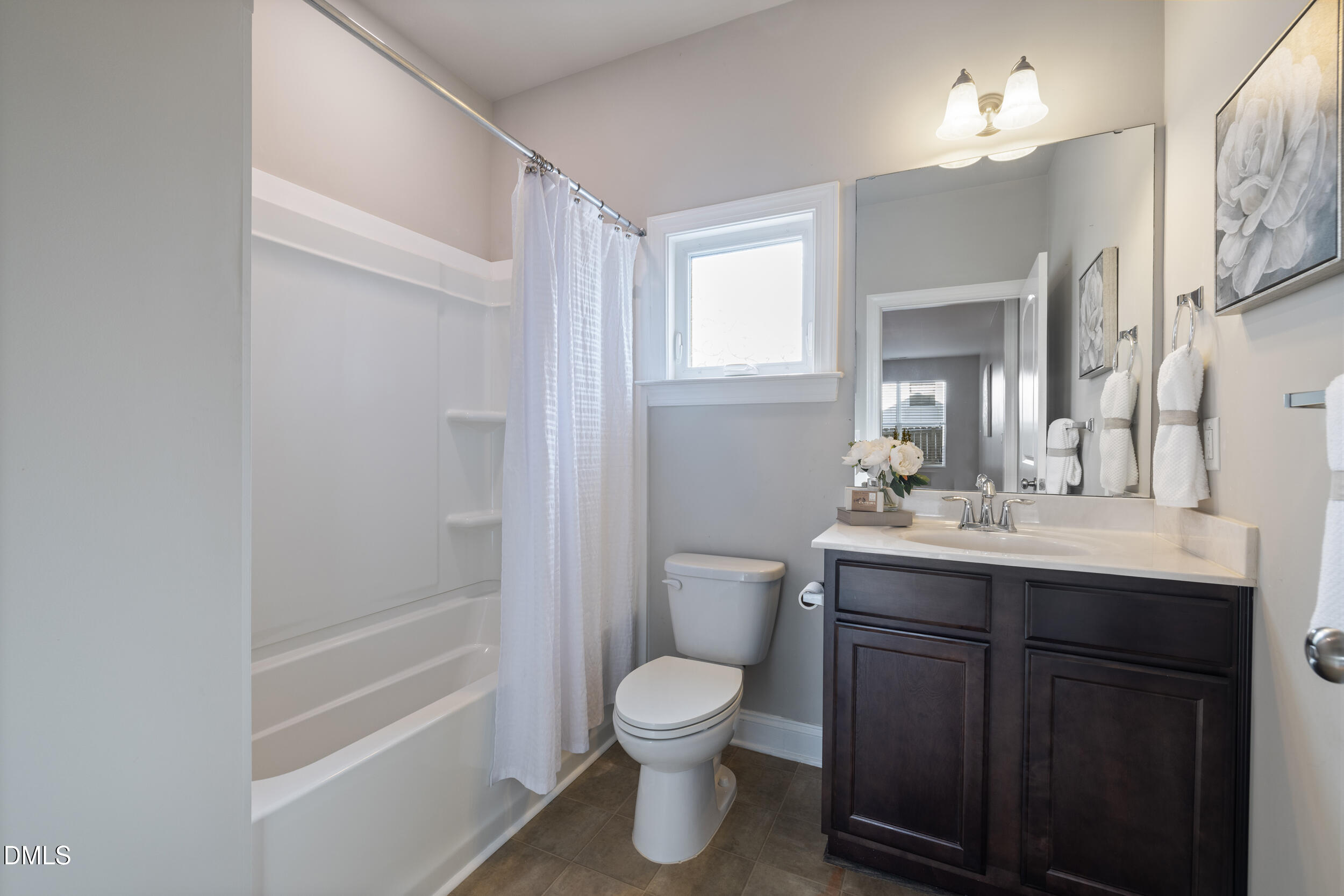 213 Forestville Road Wake Forest, NC 27587 - Photo 8 of 15 a bathroom with a toilet a sink a mirror a bathtub and vanity