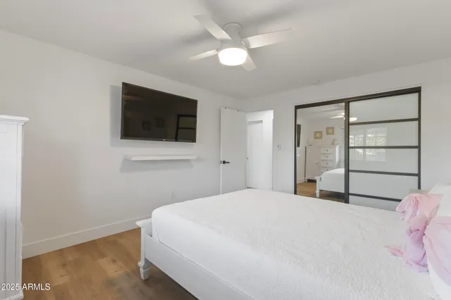 a bedroom with a bed and a flat screen tv