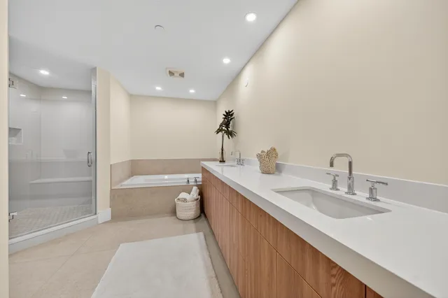 a bathroom with a granite countertop sink a toilet a mirror and bathtub
