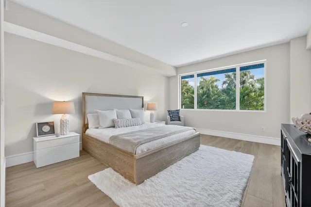 a bedroom with a large bed and a large window