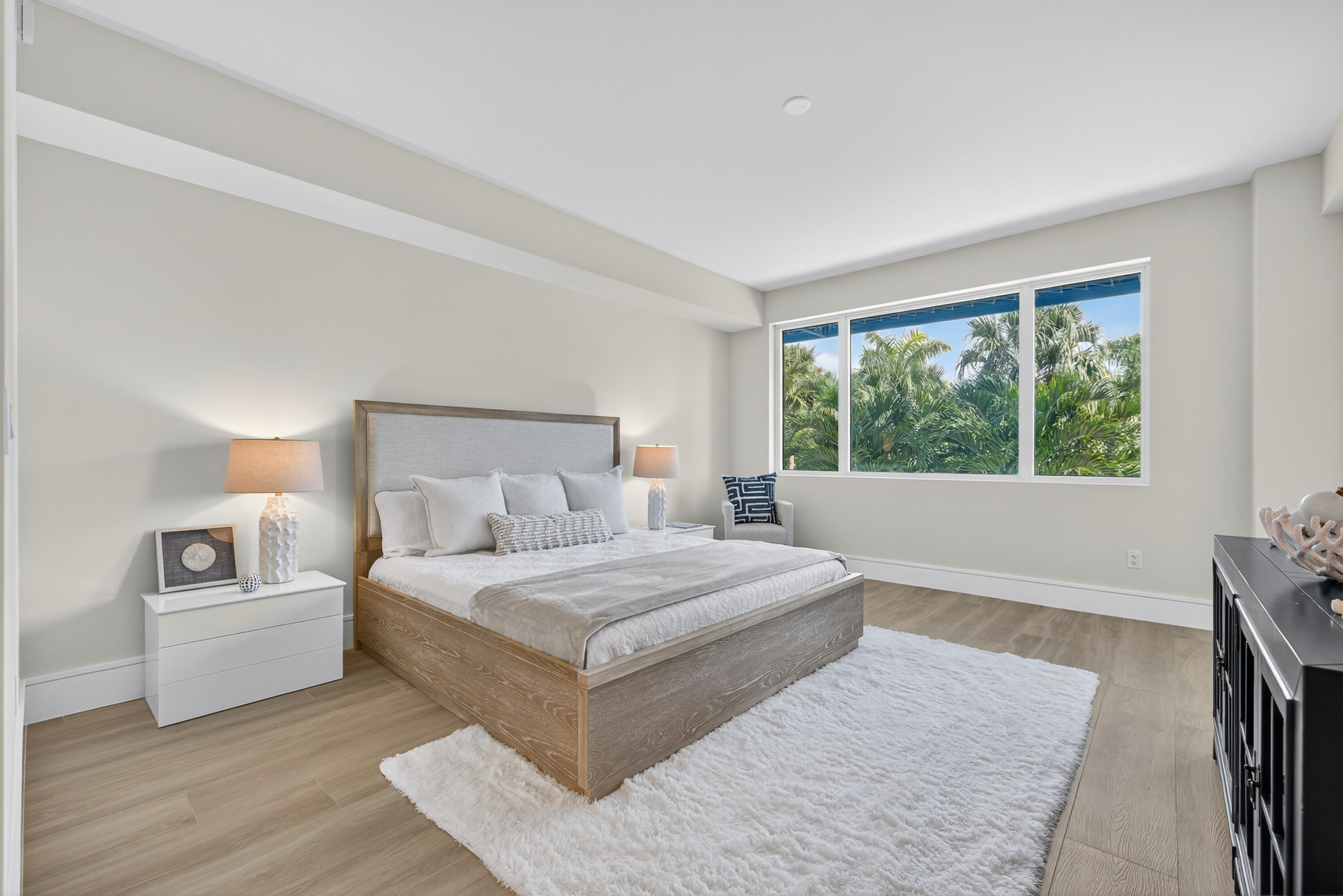 1 South Coastal Way, Unit 303 Jupiter, FL 33477 - Photo 14 of 61 a bedroom with a large bed and a large window