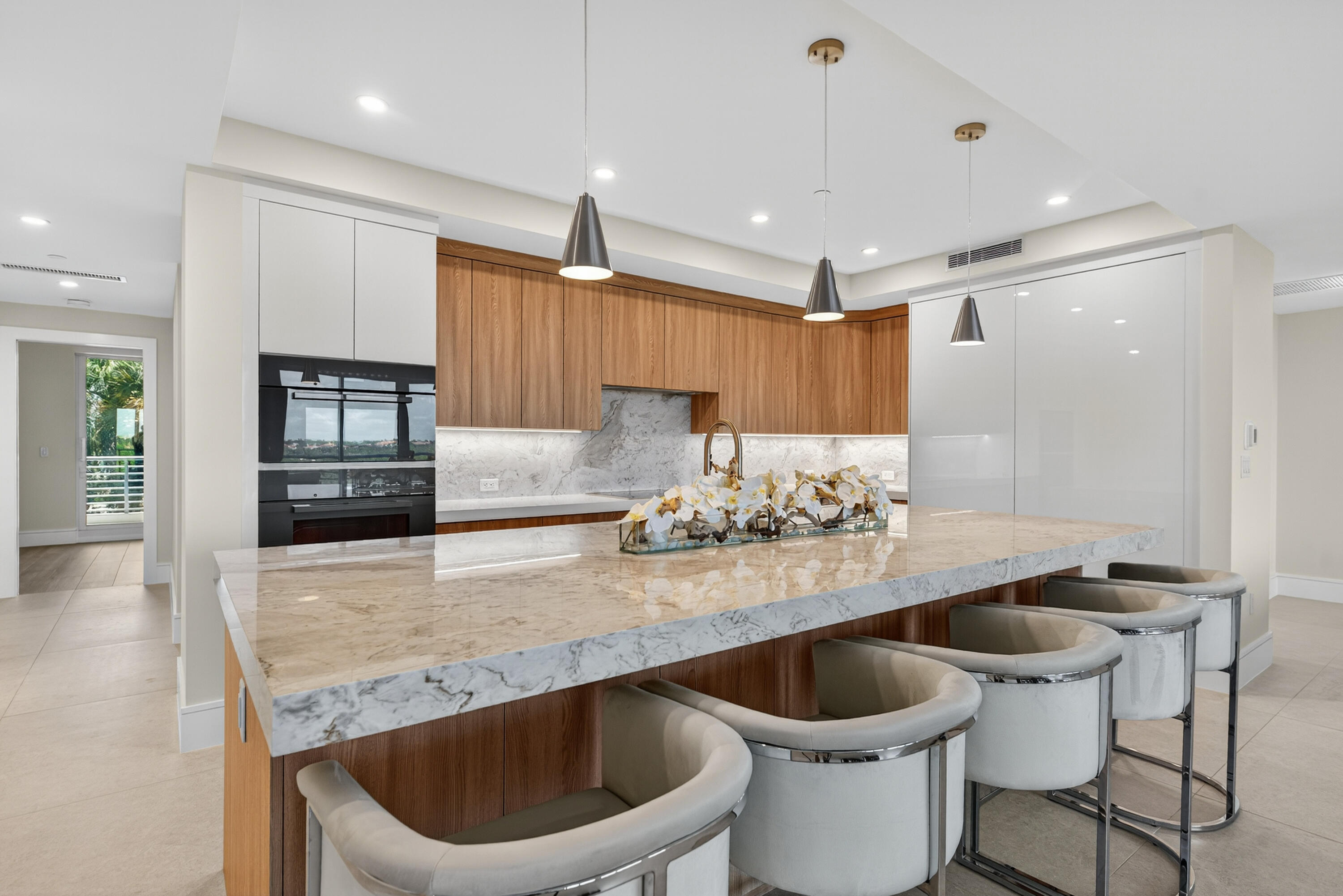 1 South Coastal Way, Unit 303 Jupiter, FL 33477 - Photo 3 of 61 a kitchen with a table and chairs