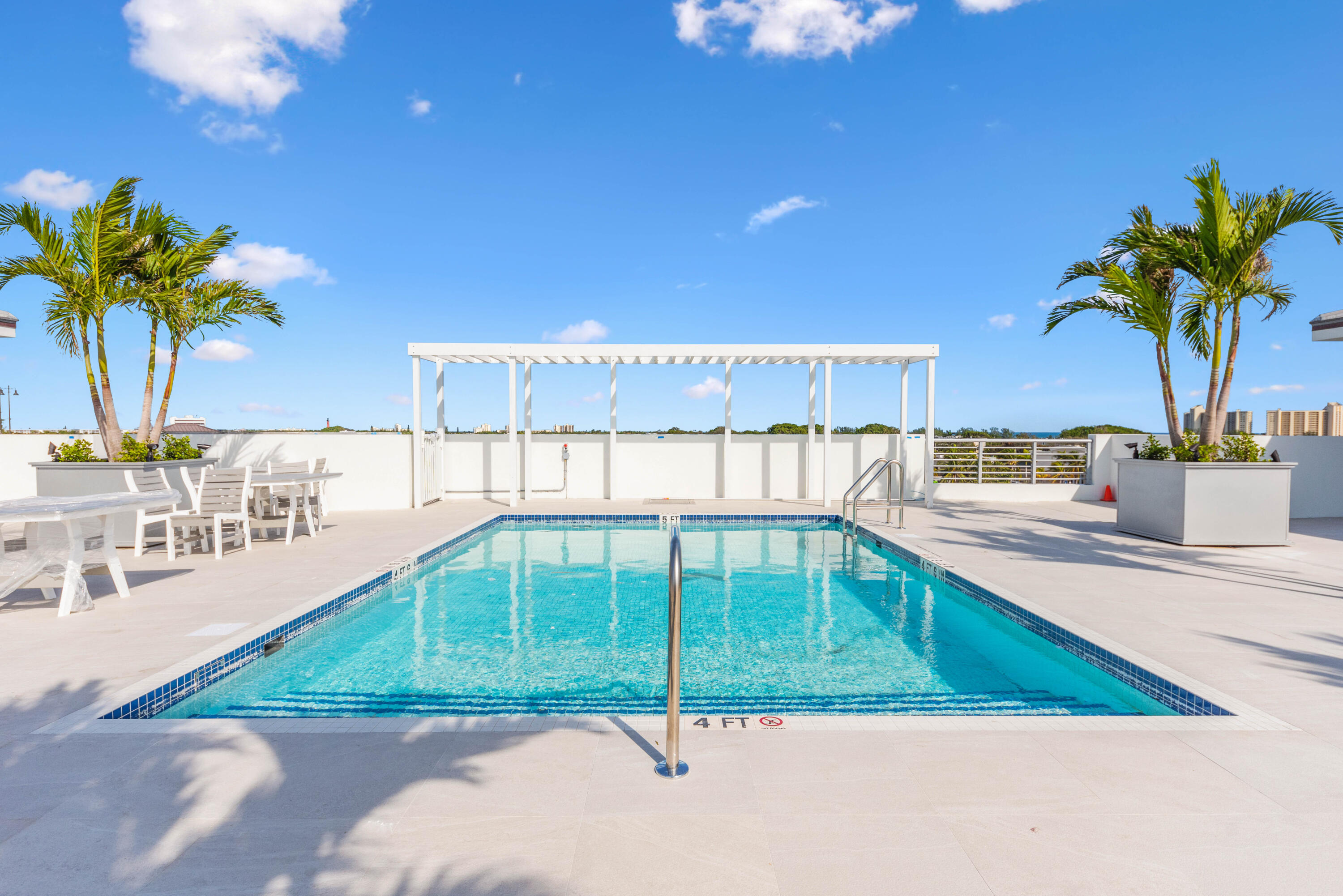 1 South Coastal Way, Unit 303 Jupiter, FL 33477 - Photo 34 of 61 a view of a swimming pool and a patio