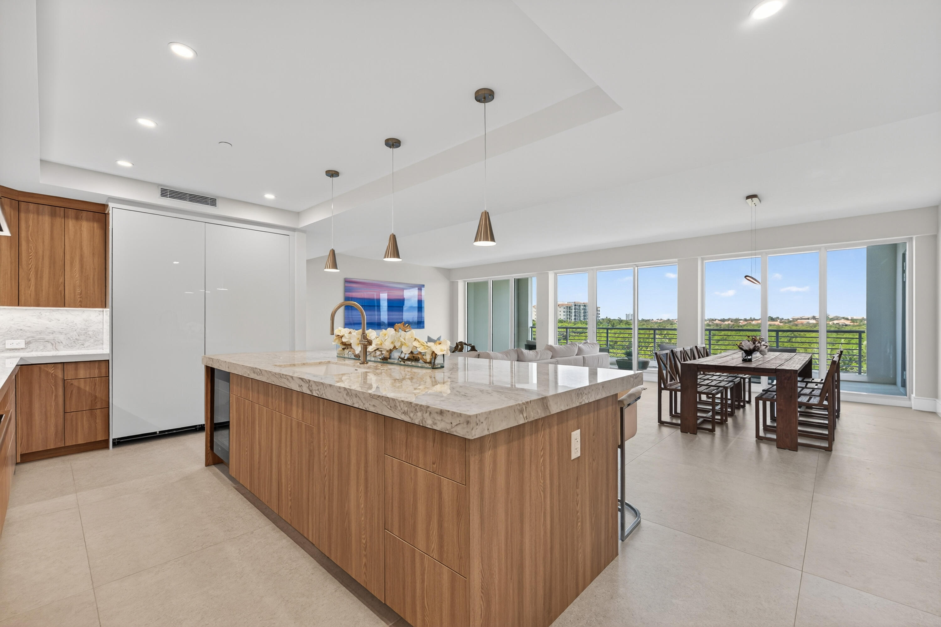 1 South Coastal Way, Unit 303 Jupiter, FL 33477 - Photo 4 of 61 a kitchen with kitchen island a sink table and chairs