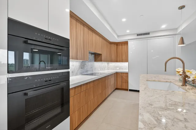 a kitchen with granite countertop a stove and a sink