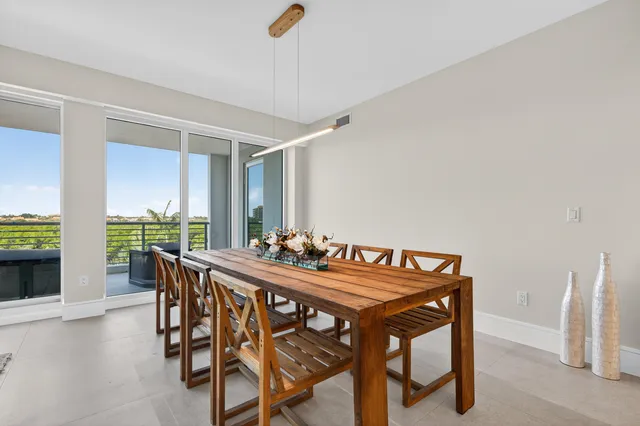 a view of a dining room with furniture and a potted plant