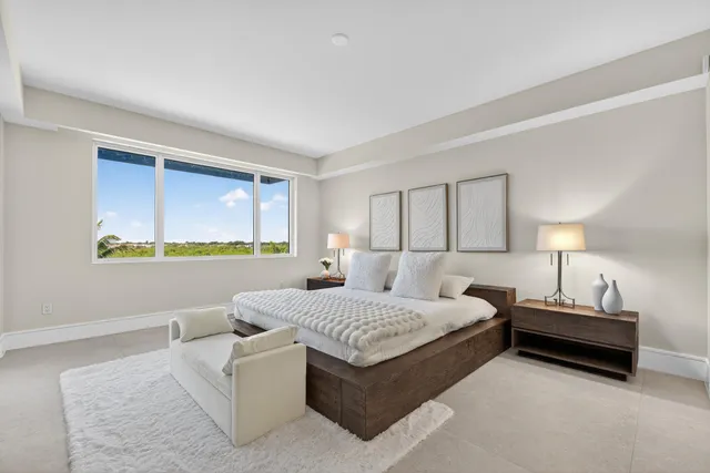 a bedroom with a bed lamp and a window