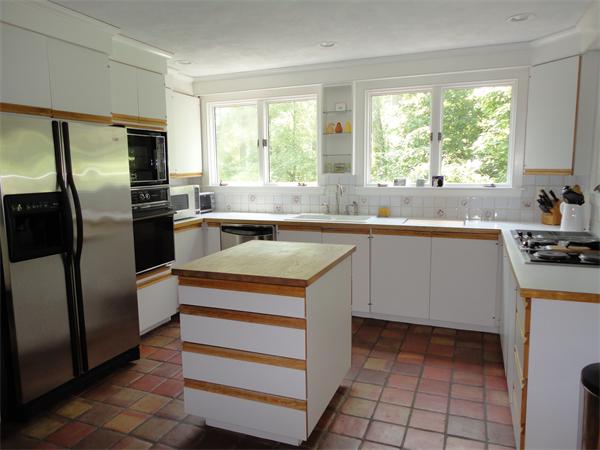 294 Pope Road Acton, MA 01720 - Photo 10 of 30 a kitchen with stainless steel appliances granite countertop a sink stove and refrigerator