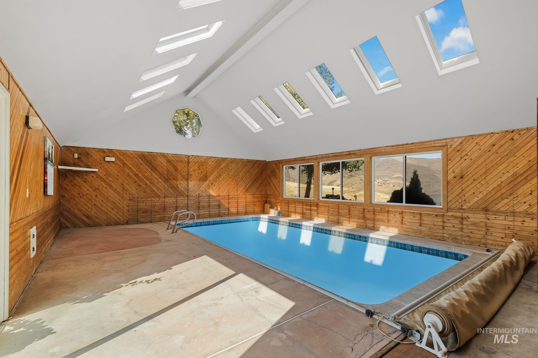 531 Silcott Road Clarkston, WA 99403 - Photo 19 of 43 Indoor swimming pool featuring an angled ceiling with multiple skylights