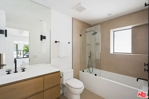 a bathroom with a bathtub and shower