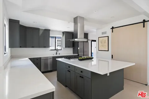 a kitchen with a sink stove top oven and cabinets