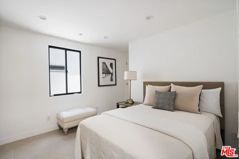 a bedroom with a bed and a chair