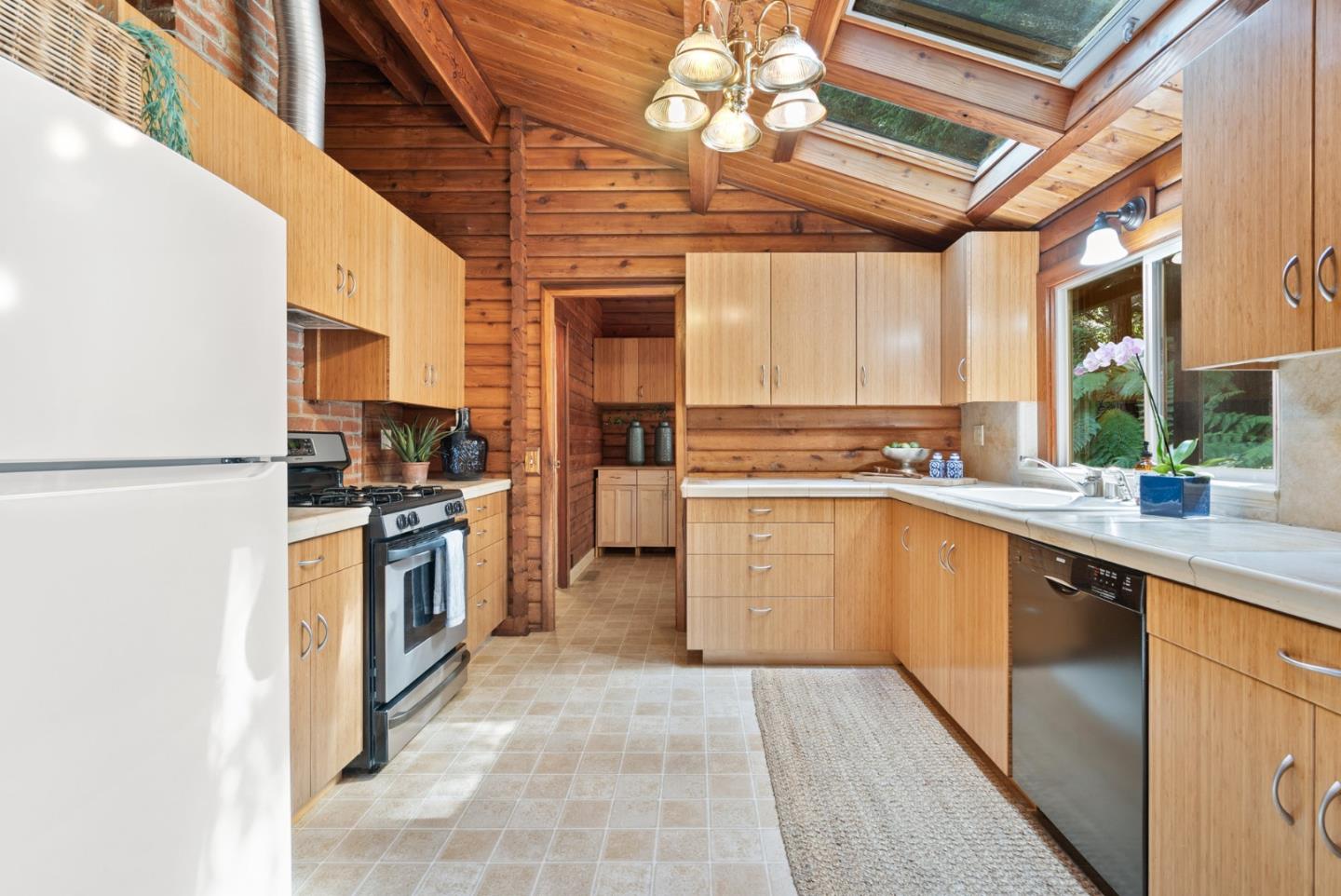 605 Waldeberg Road Ben Lomond, CA 95005 - Photo 11 of 45 a kitchen with stainless steel appliances granite countertop a stove and a refrigerator