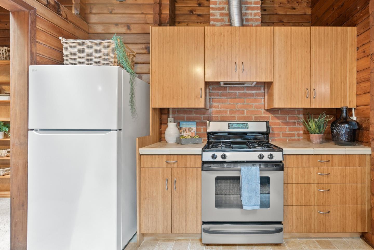 605 Waldeberg Road Ben Lomond, CA 95005 - Photo 13 of 45 a kitchen with granite countertop cabinets and refrigerator