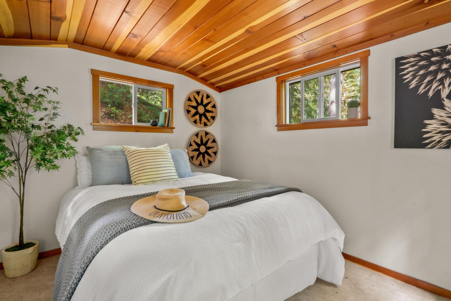 605 Waldeberg Road Ben Lomond, CA 95005 - Photo 40 of 45 a bedroom with a large bed and a potted plant