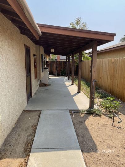 833 West Perdew Avenue Ridgecrest, CA 93555 - Photo 8 of 8 a view of a patio with a table and chairs under an umbrella