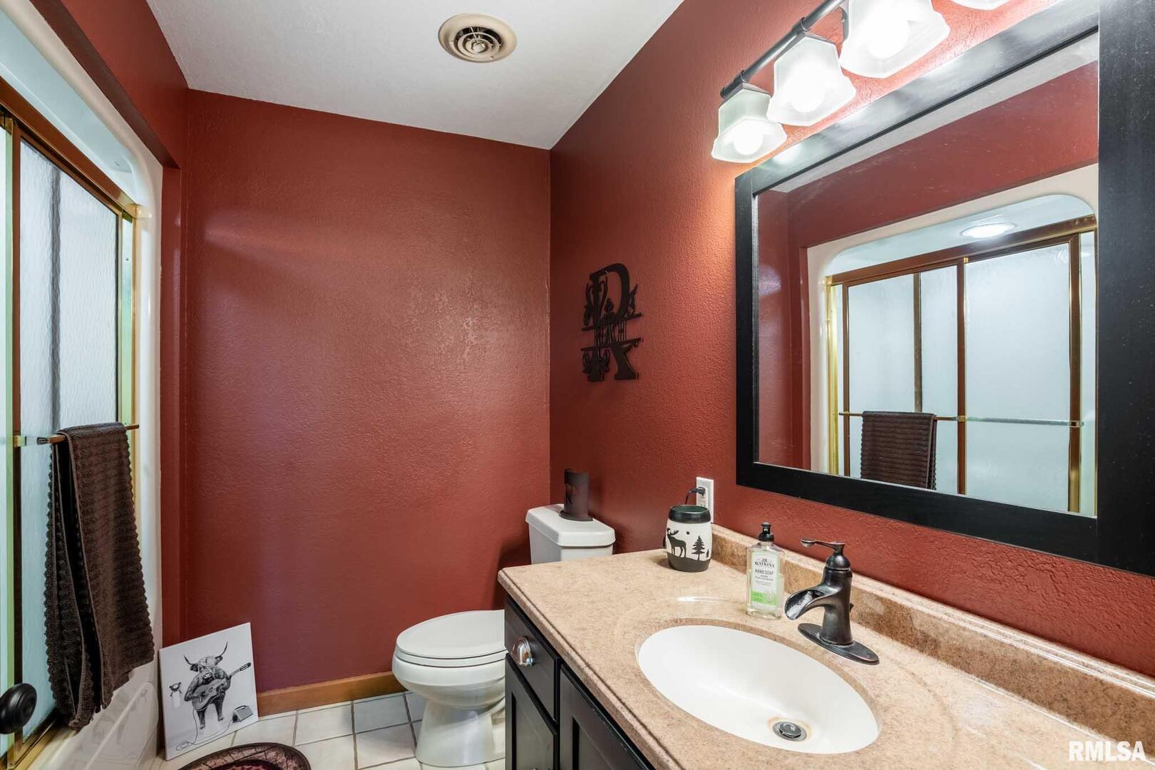 2145 Lick Creek Road Anna, IL 62906 - Photo 29 of 64 a bathroom with a granite countertop sink toilet and mirror
