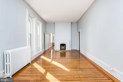 an empty room with wooden floor